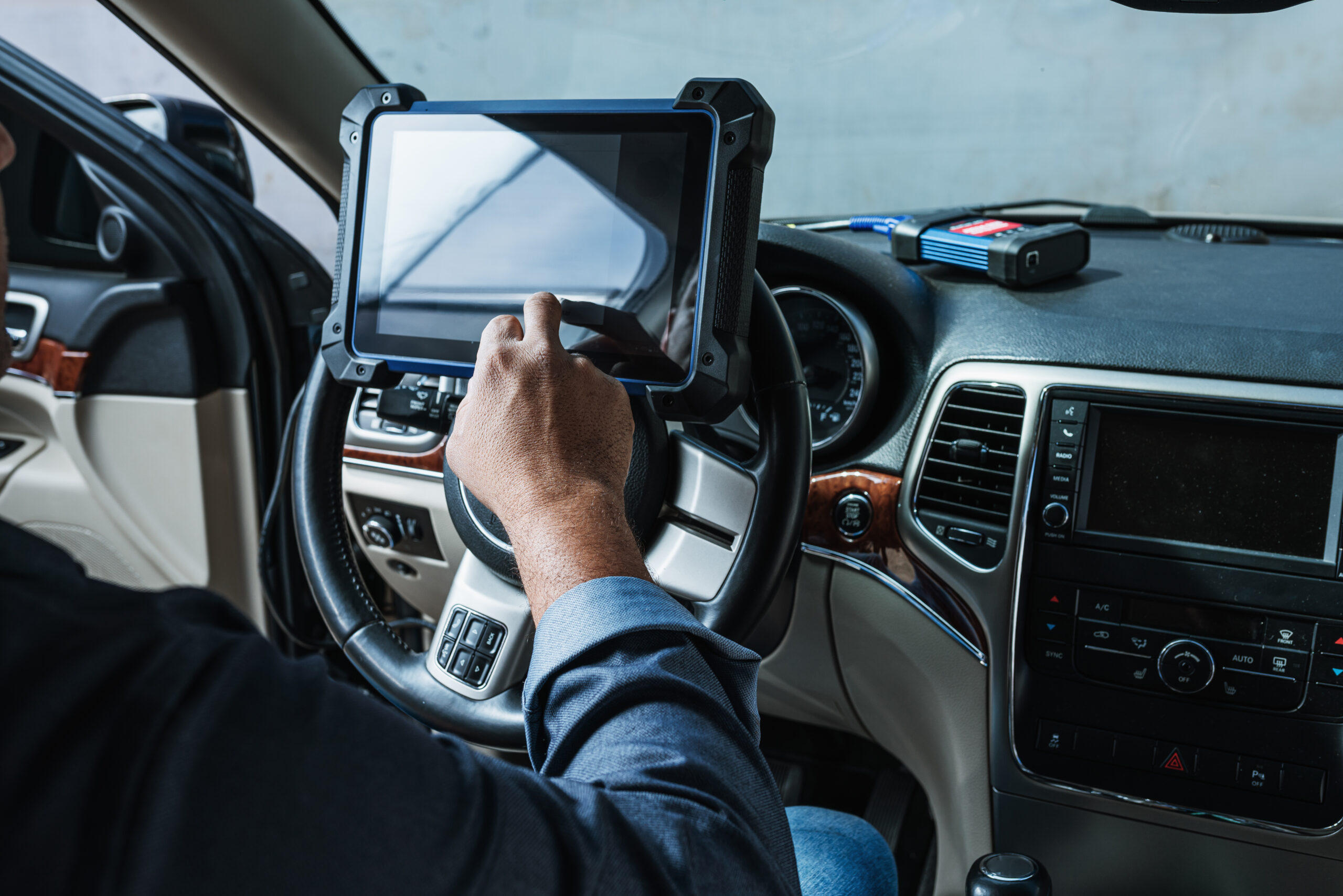 Car diagnostic Technical inspection car electronics A Latin man holds a digitizing device